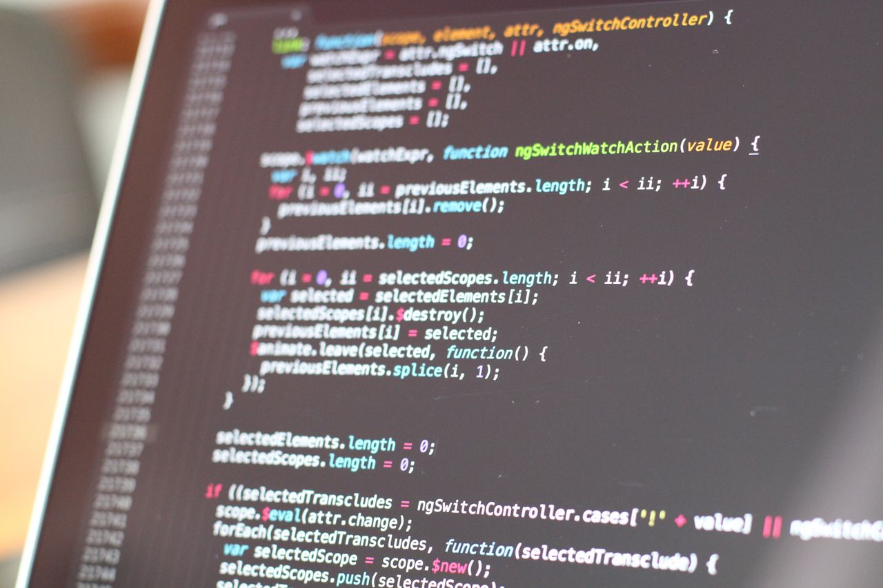Home Close-up view of colorful code on a laptop screen, showcasing programming concepts.
